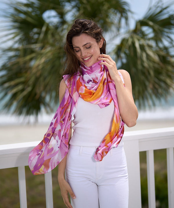 Hot pink oblong scarf featuring a striking abstract floral print in vibrant pink tones for a bold statement finish. Made from silky, lightweight fabric with a finished hem for a polished look and versatile styling.