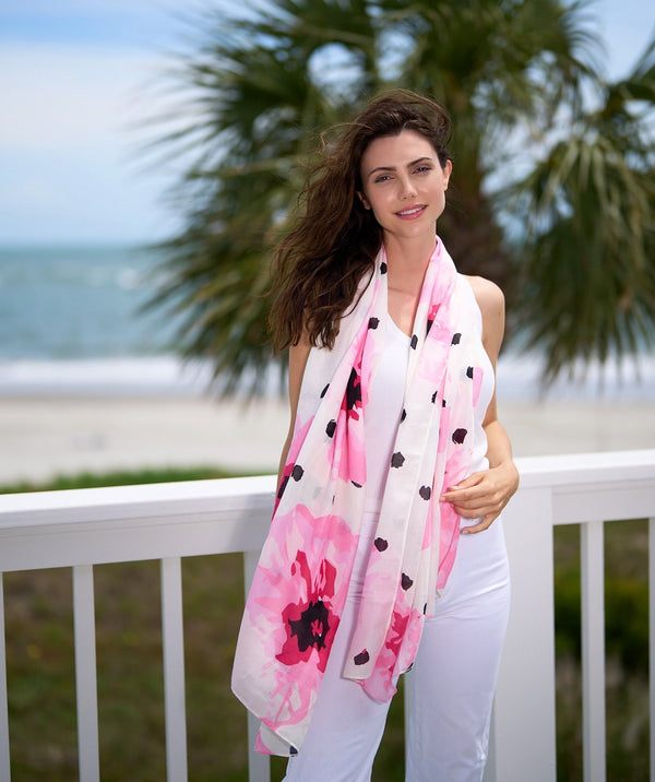 Hot pink oblong summer scarf featuring a contrasting floral and polka dot print for a bold patterned finish. Made from soft, lightweight fabric with a smooth hand feel.