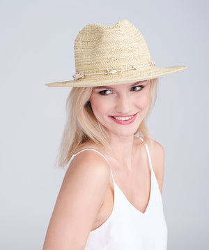 Natural straw fedora hat with shell bead trim, adjustable fit and UPF 50 sun protection for beach, holiday and summer outdoor wear.