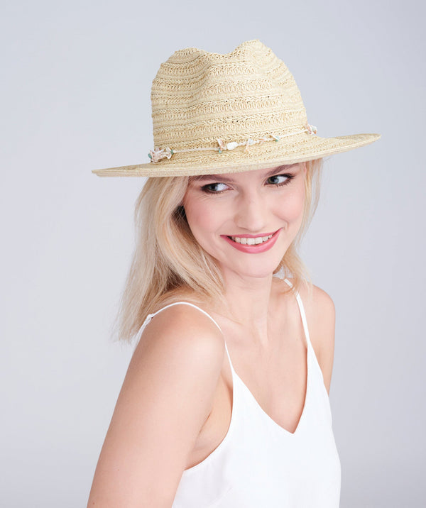 Natural straw fedora hat with shell bead trim, adjustable fit and UPF 50 sun protection for beach, holiday and summer outdoor wear.